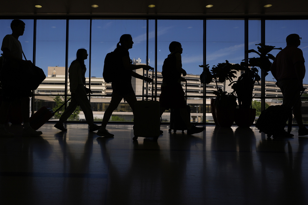 Travelers walk through the Philadelphia International Airport