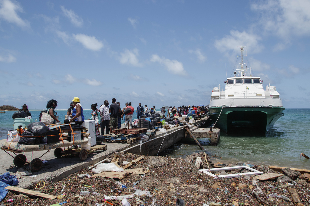 People whose homes were destroyed by Hurricane Beryl wait to be evacuated from Clifton, Union Island, St. Vincent and the Grenadines