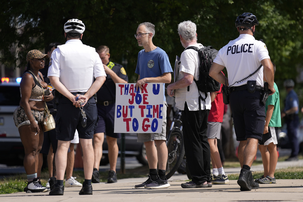A protester holds a sign ahead of President Joe Biden
