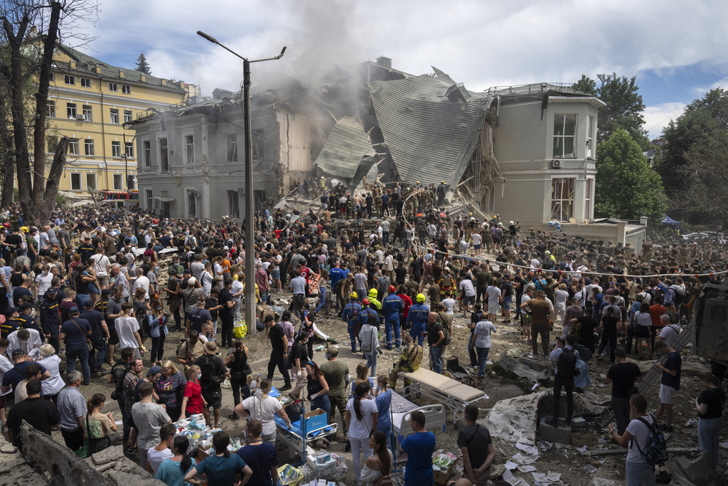 Rescuers and volunteers clean up the rubble and search victims after Russian missile hit the country