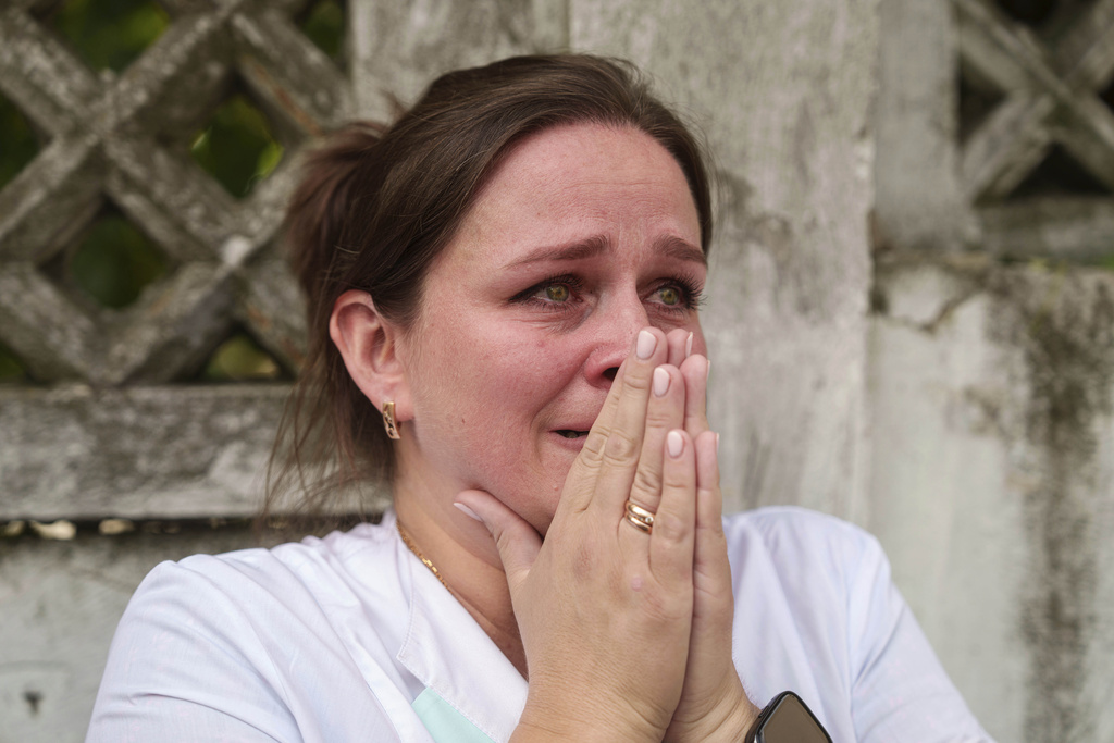 A woman reacts near the site of Okhmatdyt children’s hospital hit by Russian missiles