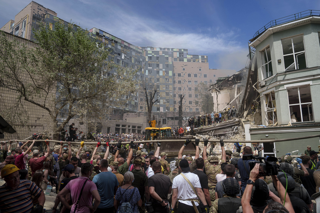 Rescue workers at the site of Okhmatdyt children’s hospital hit by Russian missiles