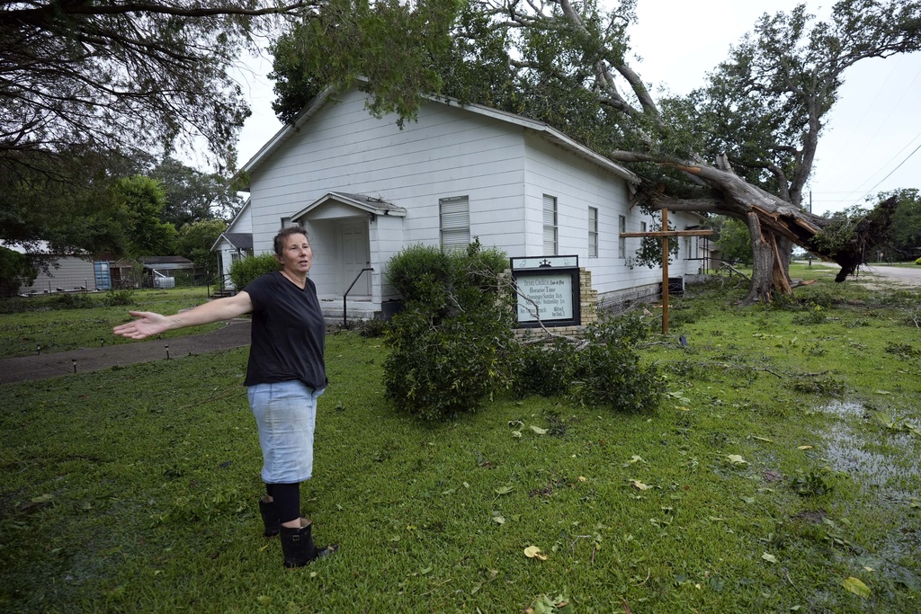 Ann McCauley examines the damage at Bethel Church after Hurricane Beryl moved through the area