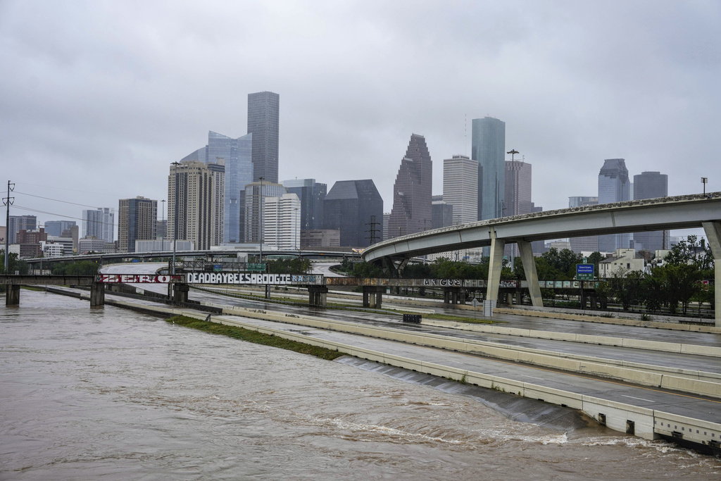 Floodwaters rise next to the I-10 freeway just after Hurricane Beryl made landfall