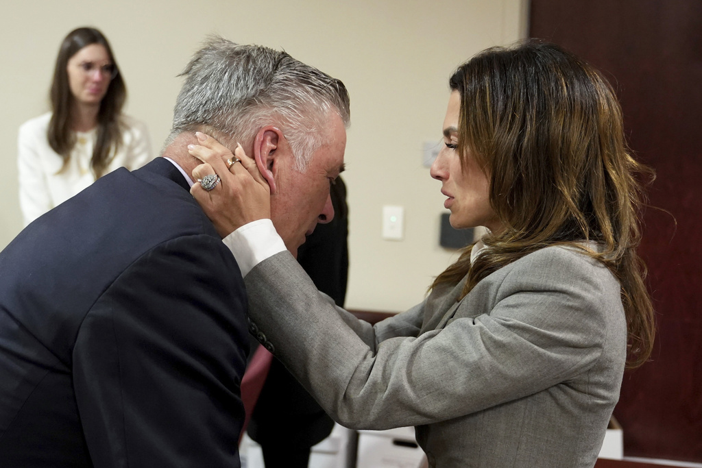 Actor Alec Baldwin, left, and his wife Hilaria embrace after a judge threw out the involuntary manslaughter case