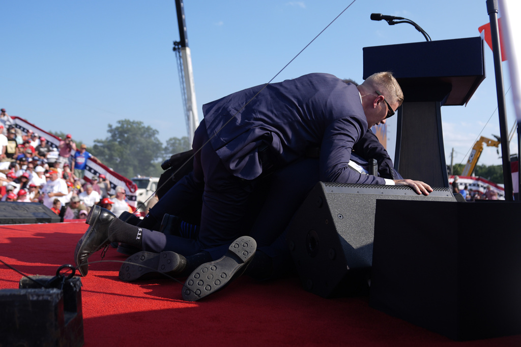 Republican presidential candidate former President Donald Trump is covered by U.S. Secret Service agents at a campaign rally, Saturday, July 13, 2024, in Butler, Pa. 