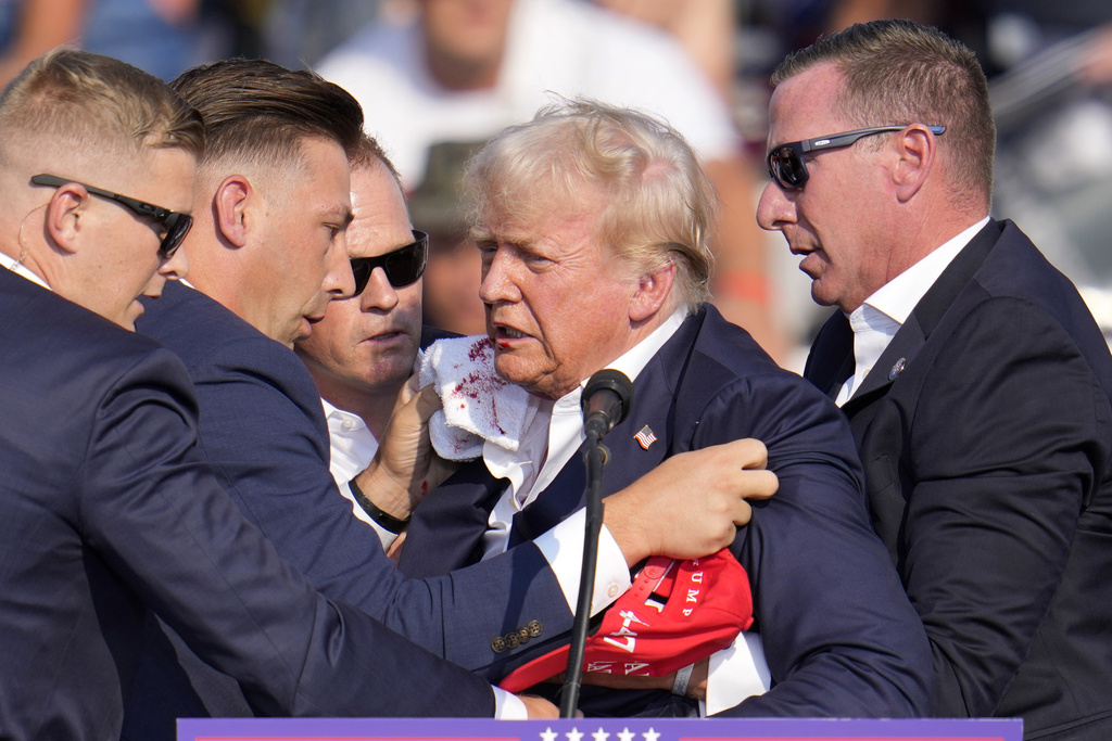 Republican presidential candidate former President Donald Trump is helped off the stage at a campaign event in Butler, Pa.