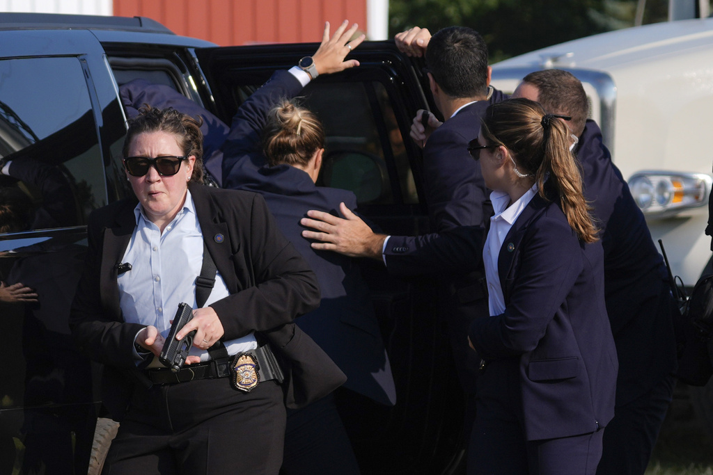 Republican presidential candidate former President Donald Trump is evacuated by U.S. Secret Service agents at a campaign rally