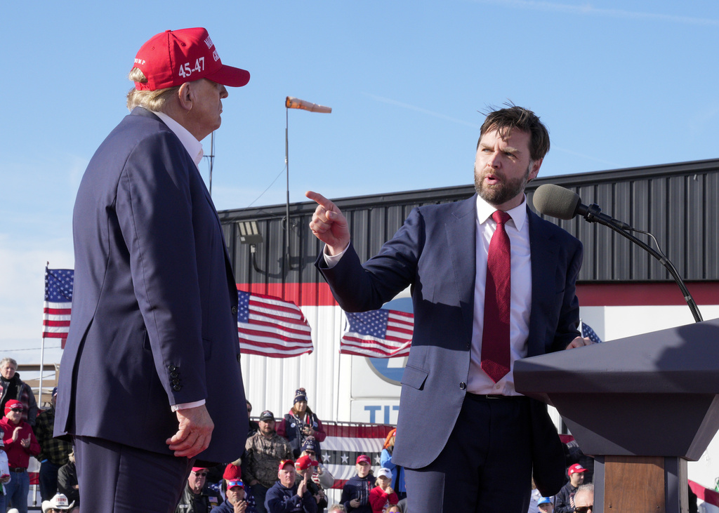 Sen. J.D. Vance, R-Ohio, right, points toward Republican presidential candidate former President Donald Trump at a campaign rally in Vandalia, Ohio