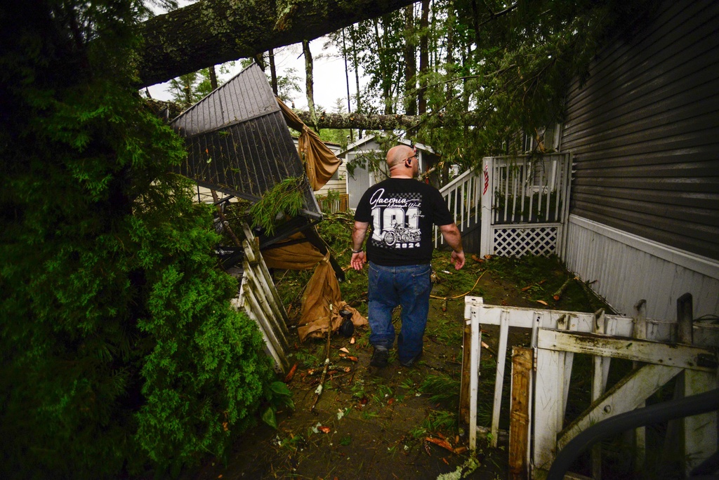 Jon Scott, a resident of Tanglewood Estates in Keene, N.H., looks at the damage to his home 