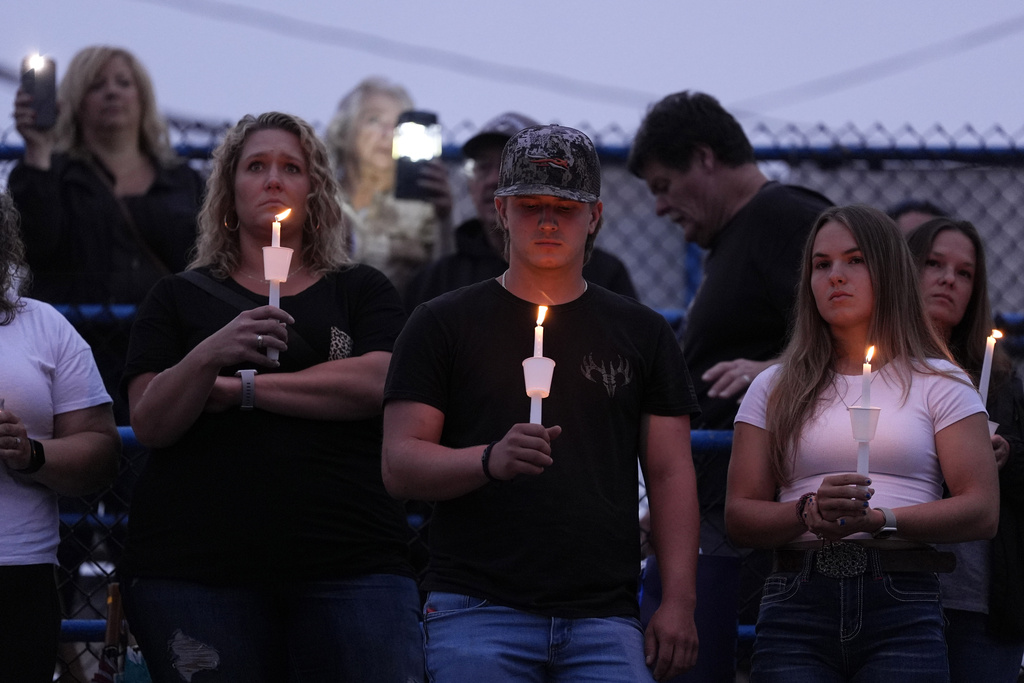 Family, friends, and community members attend a candlelight vigil for Corey Comperatore