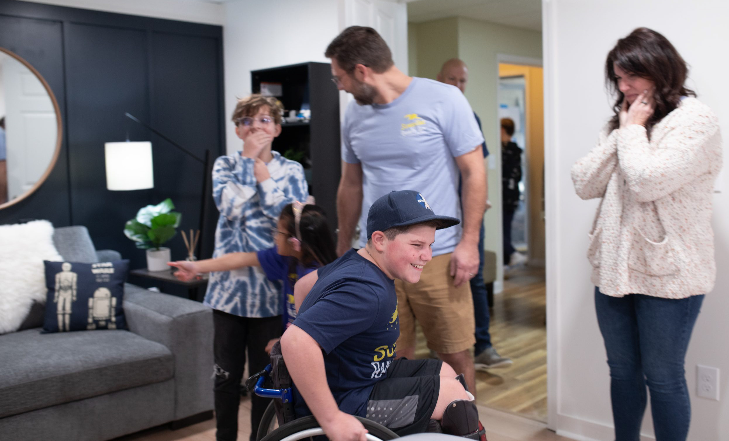 Young boy in a wheelchair with family