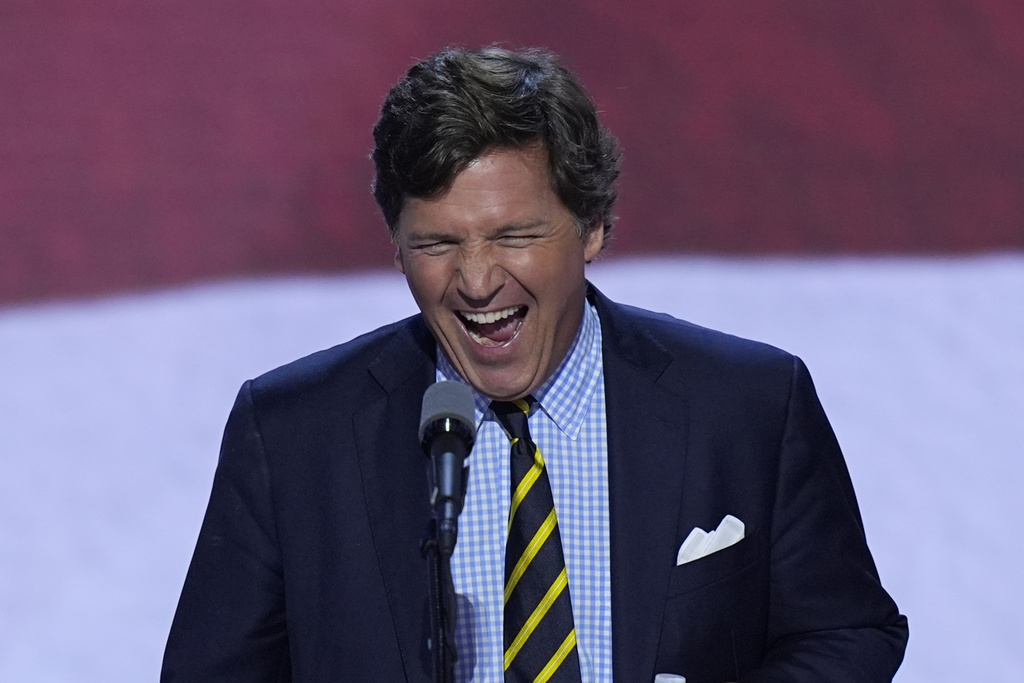 Tucker Carlson walks up to the podium to speak on the final day of the Republican National Convention