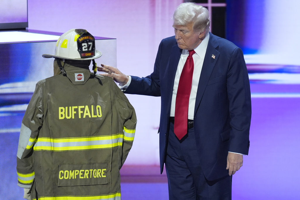 Republican presidential candidate former President Donald Trump standing next to the uniform of Corey Comperatore 