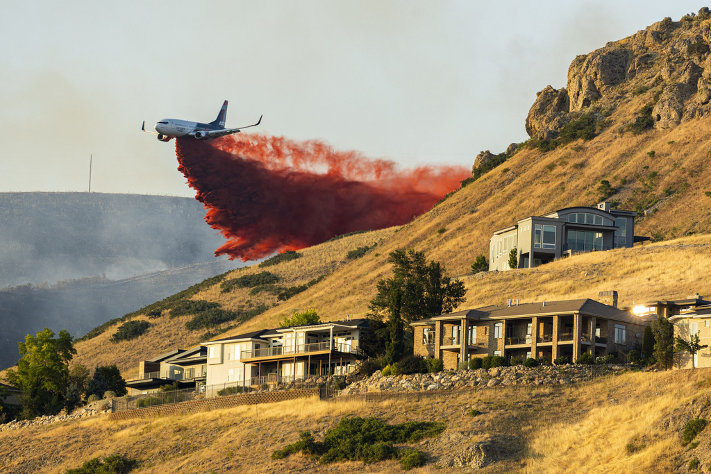 A plane drops fire retardant as the Sandhurst Fire burns