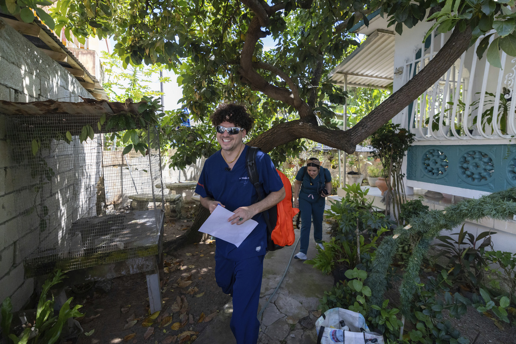 Dr. Pedro Juan Vázquez, better known by his stage name PJ Sin Suela, makes door-to-door rounds in Loiza, Puerto Rico