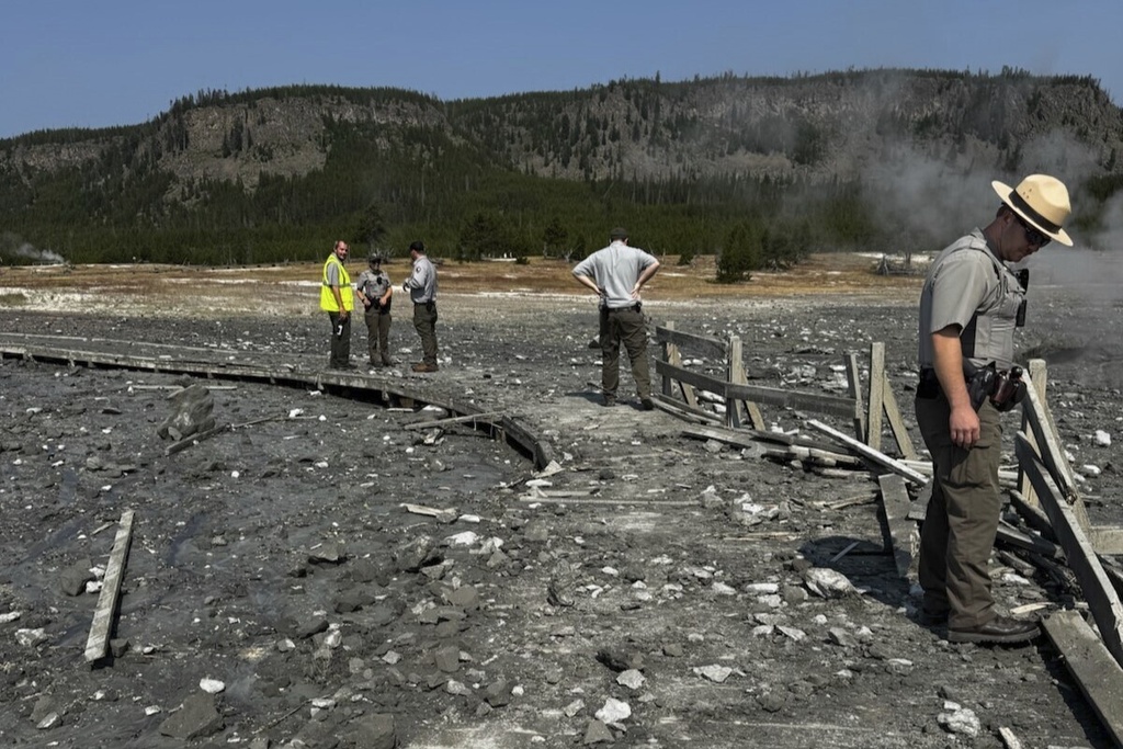 Park staff assess the damage to Biscuit Basin boardwalks after a hydrothermal explosion at Biscuit Basin in Yellowstone National Park, Wyo.