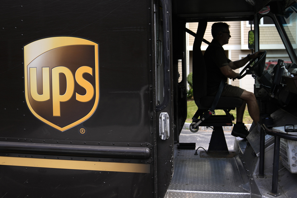 A United Parcel Service driver steers through a neighborhood while delivering packages in Haverhill, Mass.