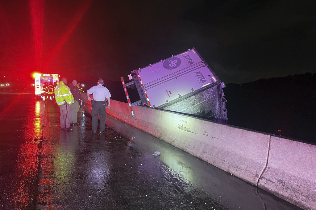 A tractor trailer dangles from a bridge on Interstate 75 near Tampa. The driver was killed. The truck’s cab broke off and dropped into the Tampa Bypass Canal. 