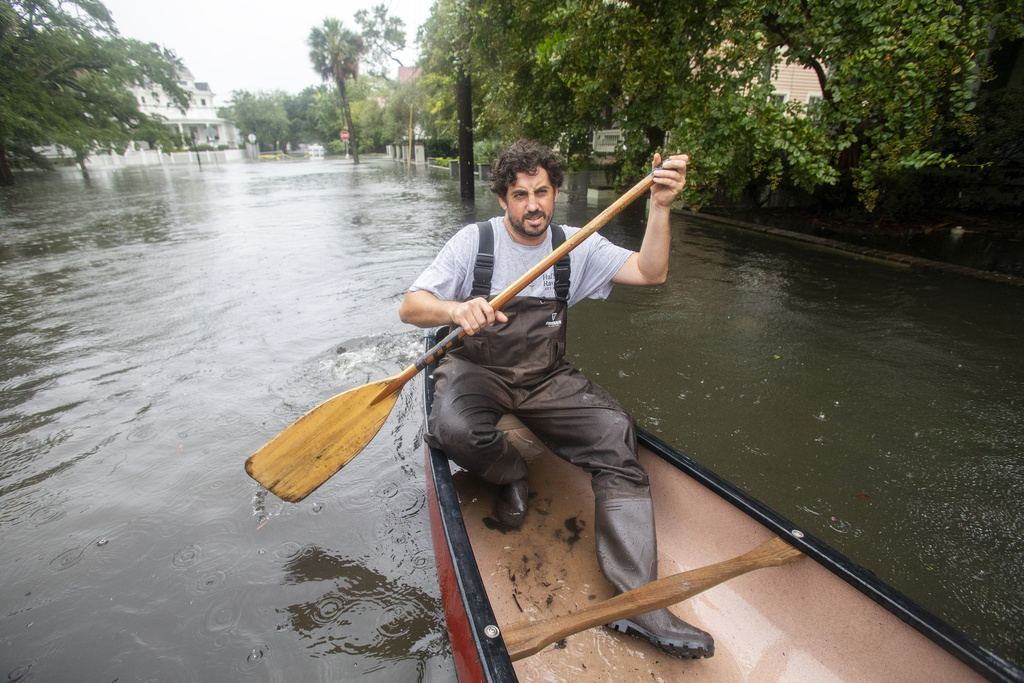 Trip Hamilton, from Charleston, S.C., canoes down Ashley Ave in Charleston