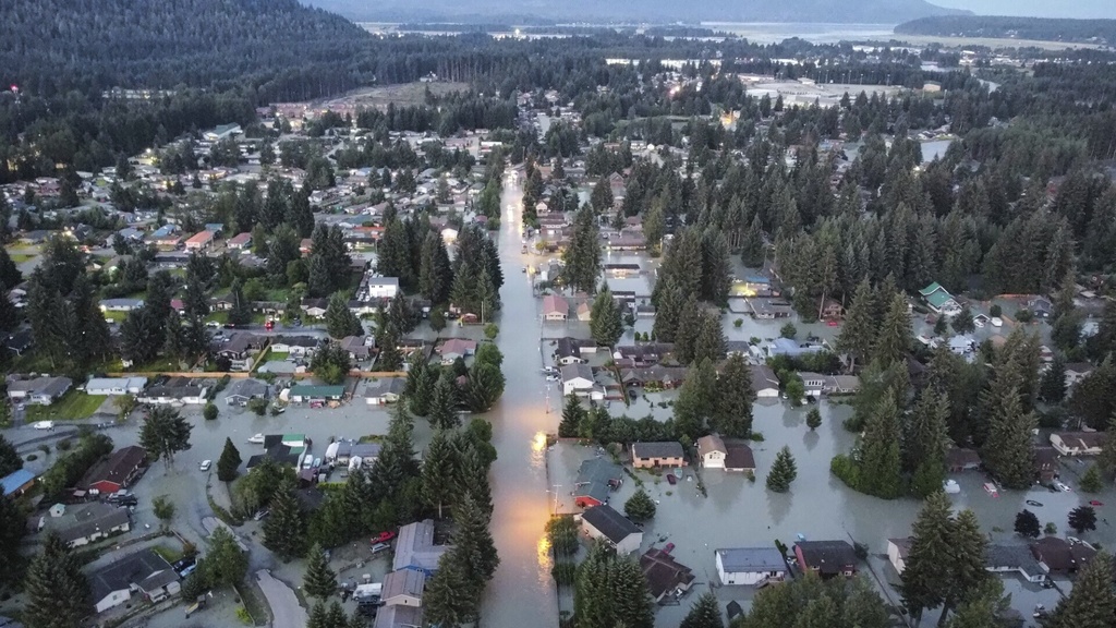 This image taken with a drone and provided by Richard Ross shows shows high water around homes and neighborhoods following an outburst of flooding from a lake dammed by the Mendenhall Glacier, Tuesday, Aug. 6, 2024, in Juneau, Alaska.