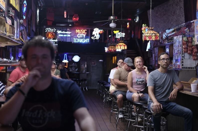 A group of people at Nashville’s Robert’s Western World listen to Christian music and words led by the Rev. Ron Blakely during Sunday Gospel Hour on Sunday, July 28, 2024, in Nashville, Tenn.