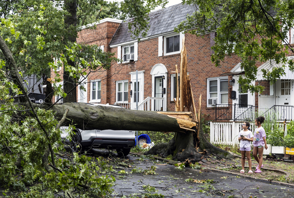 Children survey damage on Adrian Street in Harrisburg, Pa.