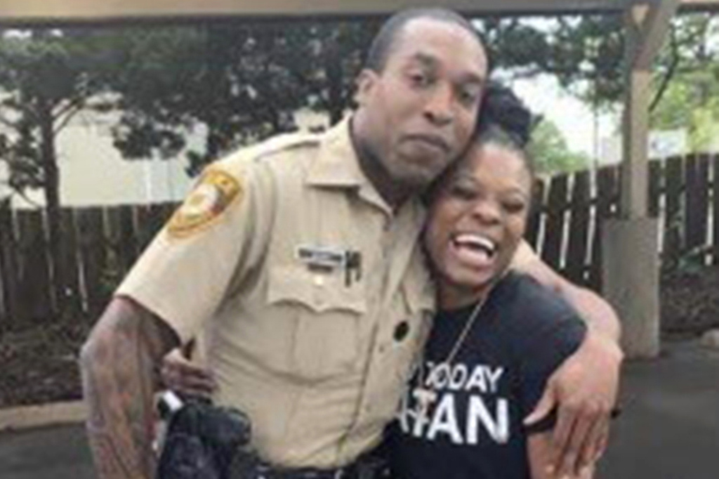 Travis Brown, when he was St. Louis County police officer, stands with Danielle Oliver