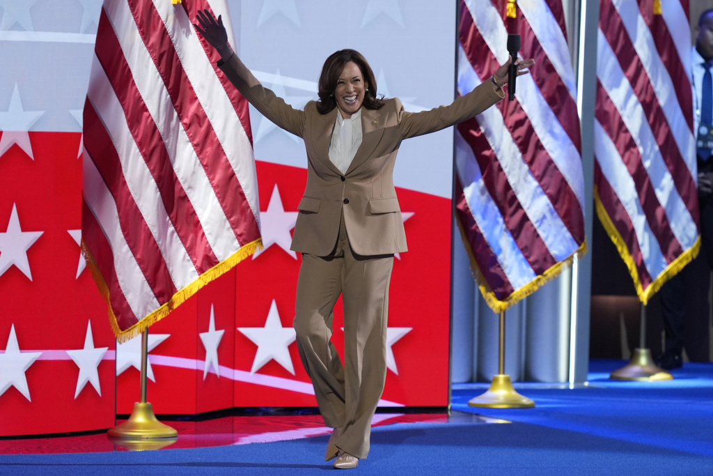 Democratic presidential nominee Vice President Kamala Harris raises her arms as she walks on stage during the Democratic National Convention