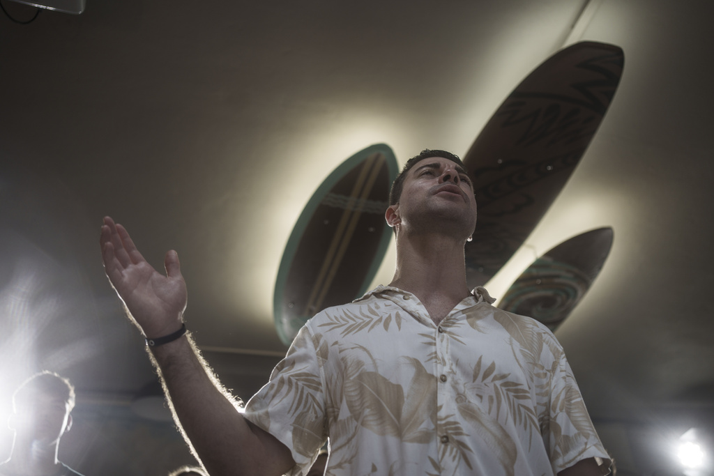 Surf Church pastor, the Rev. Samuel Cianelli, preaches to his congregation at the church in Porto, Portugal on Sunday, Aug. 18, 2024.