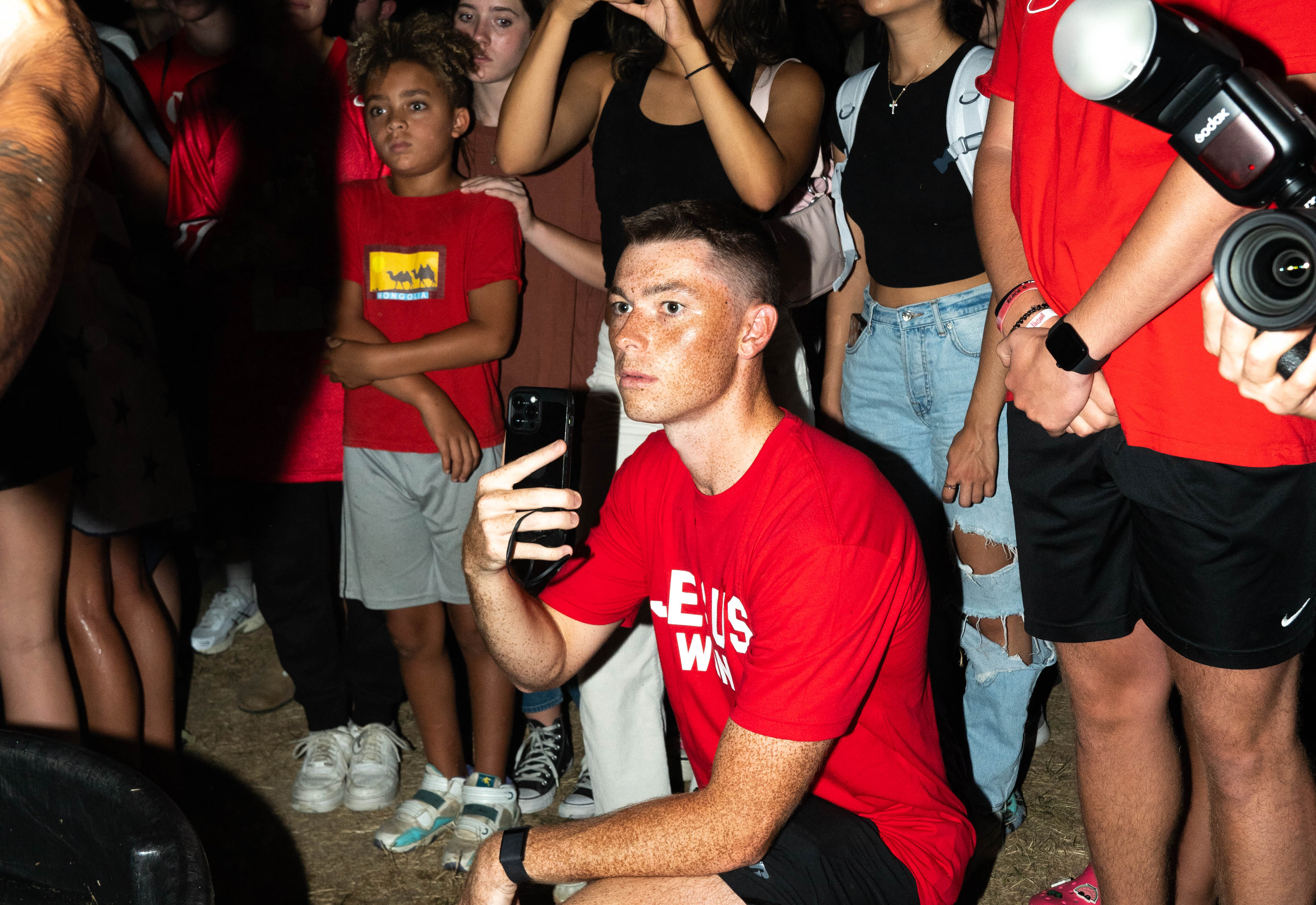 Kevin Walsh crouched with crowd behind him