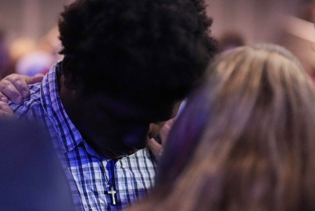 Apalachee High School student, left, is embraced during a Sunday service at Bethlehem Church in Bethlehem, Ga.