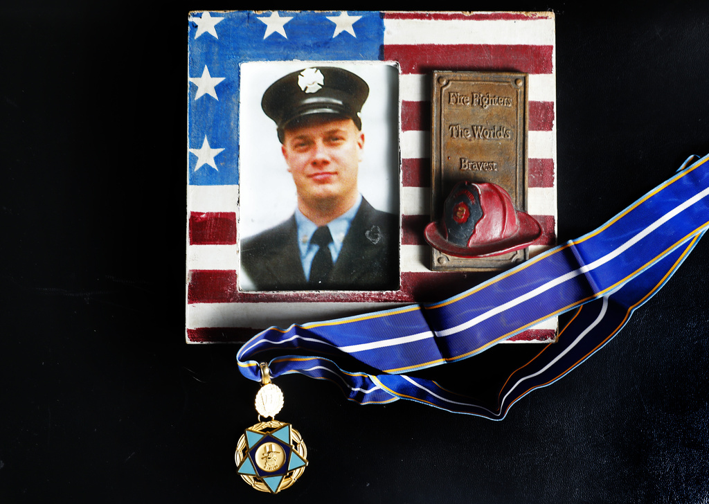 New York firefighter Christopher Michael Mozzillo, who died in the 9/11 attacks, with his 9/11 Medal of Valor