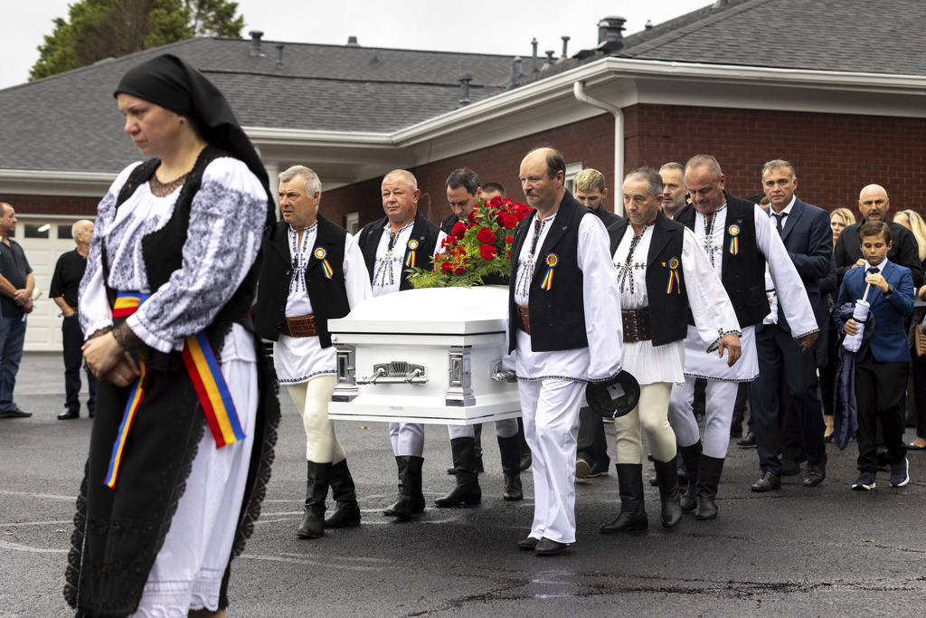 Mourners carry the casket of Ana Cristina Irimie, a math teacher killed during a shooting at Apalachee High School, after her funeral service at Hamilton Mill Memorial Chapel and Gardens in Buford, Ga.