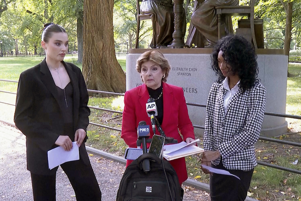 Flanked by Veronika Didusenko, left, and Danielle Hazel, right, attorney Gloria Allred, center