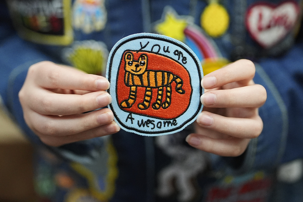 Oliver Burkhardt, 13, holds up a popular patch he designed himself