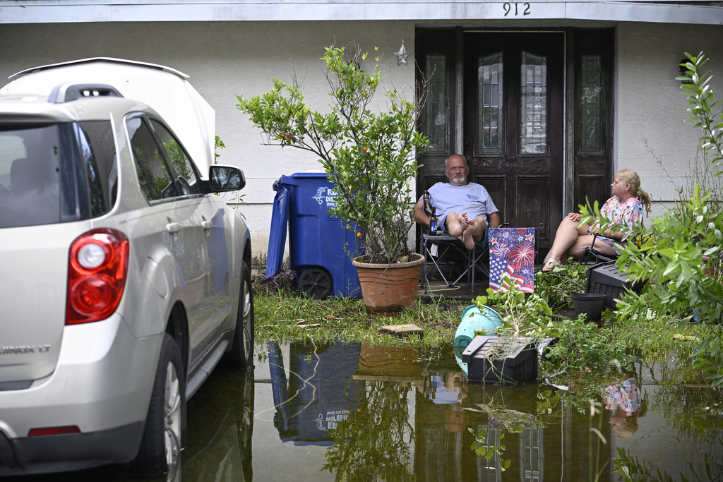 Coping with it: Andy Slone and his wife, Vickie, sit outside their home in the aftermath of Hurricane Helene in Crystal River, Fla. 