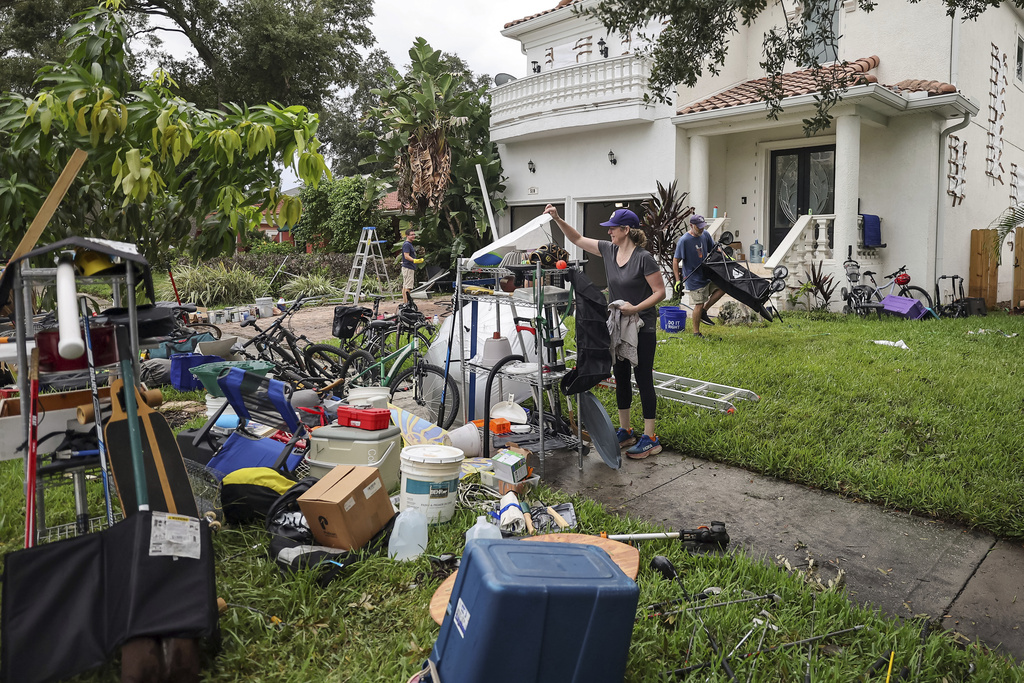 Ellie Moss, along with family and friends cleans contents of her home after flooding from Hurricane Helene on Davis Island in Tampa, Fla.