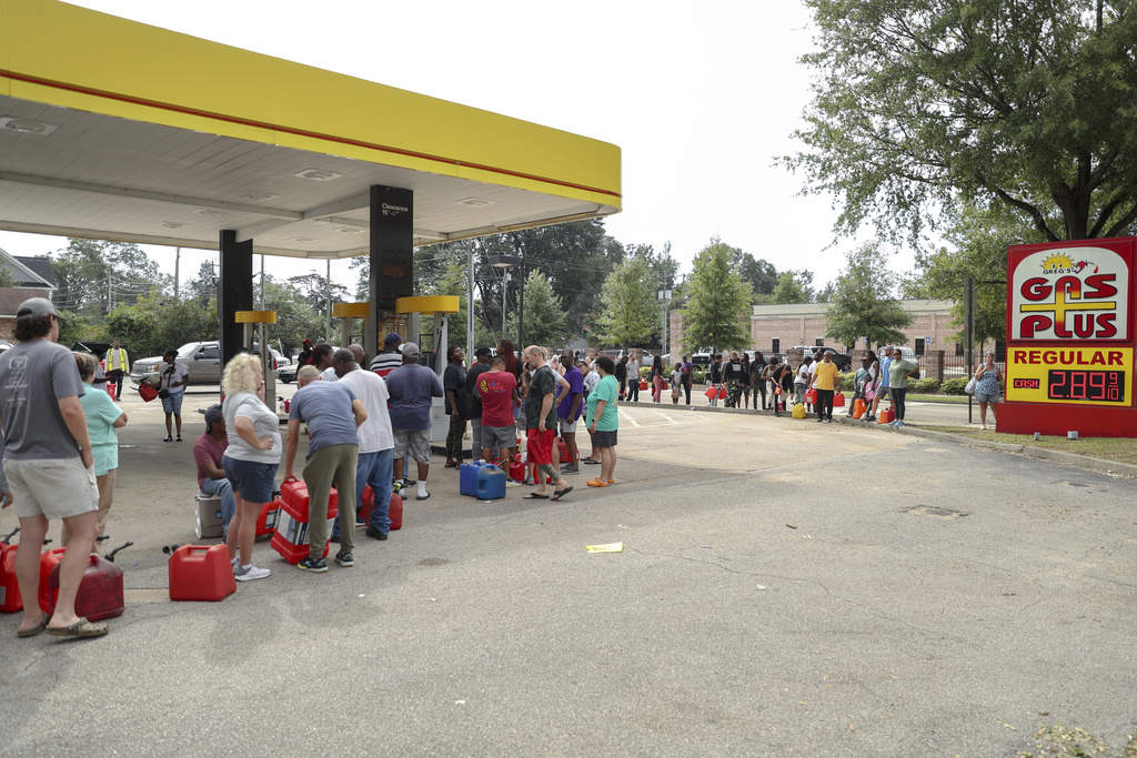 Residents wait in line with gas cans at a Gas Plus gas station in the aftermath of Hurricane Helene in North Augusta, S.C.