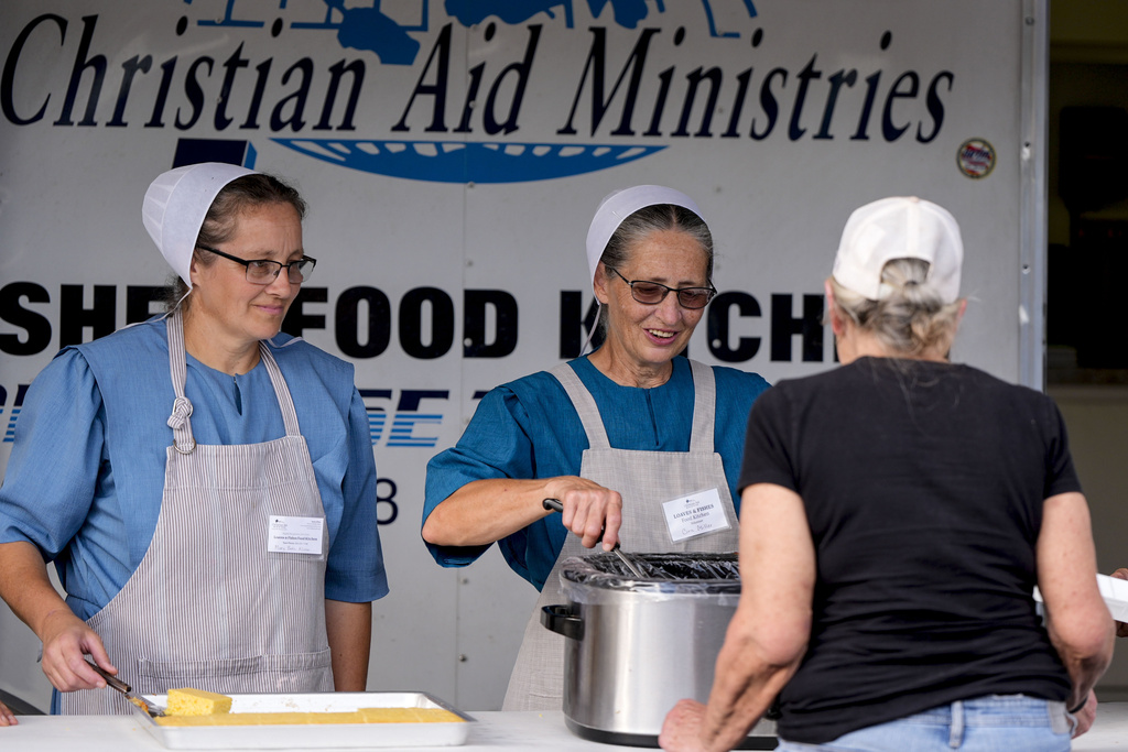 Loaves & Fishes food group serve meals for residents in the aftermath of Hurricane Helene, Wednesday, Oct. 2, 2024, in Lake Lure, N.C. 