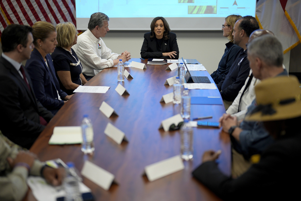 Vice President Kamala Harris receives a briefing from North Carolina Gov. Roy Cooper, center left, on the damage from Hurricane Helene