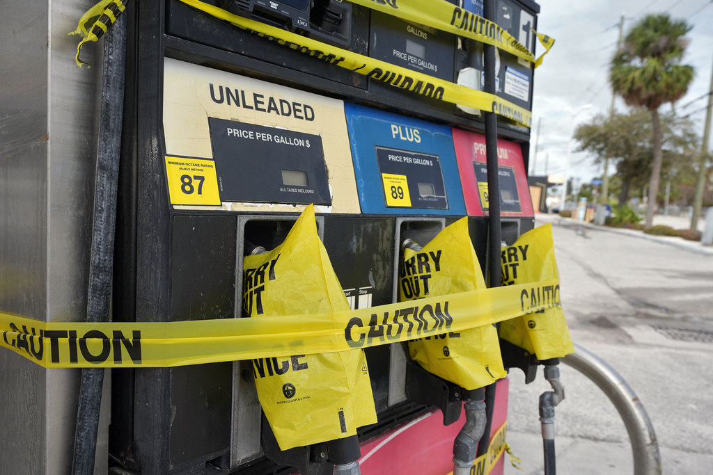 Gas pumps are covered at a station in Clearwater Beach, Fla.