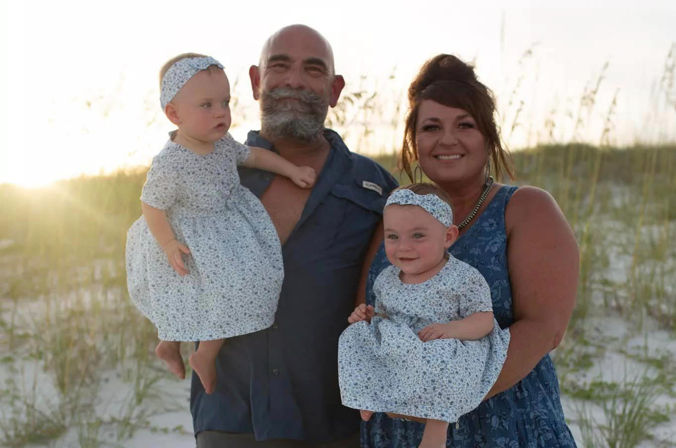 Grandparents on beach with toddler grandchildren