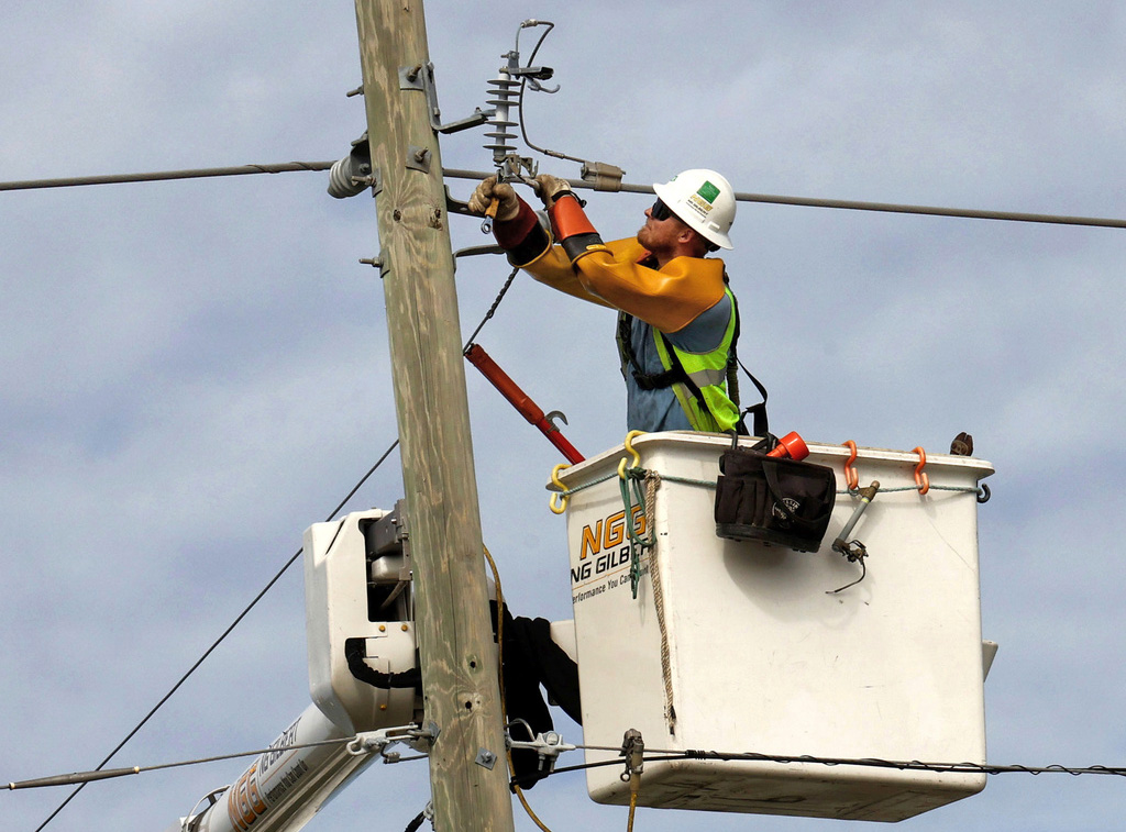 Linesman contractor for Duke Energy works on power lines along Forest City Road in Orlando