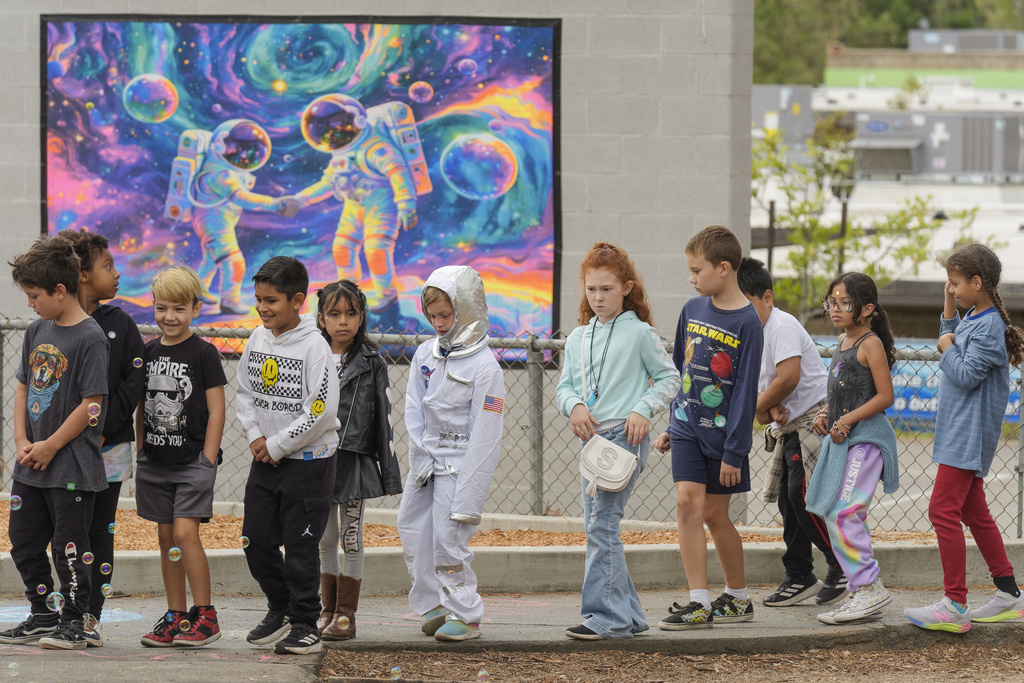 Santiago STEAM Magnet Elementary School students arrived dressed with space themed clothing at a ceremony to plant a small Giant Sequoia tree from NASA