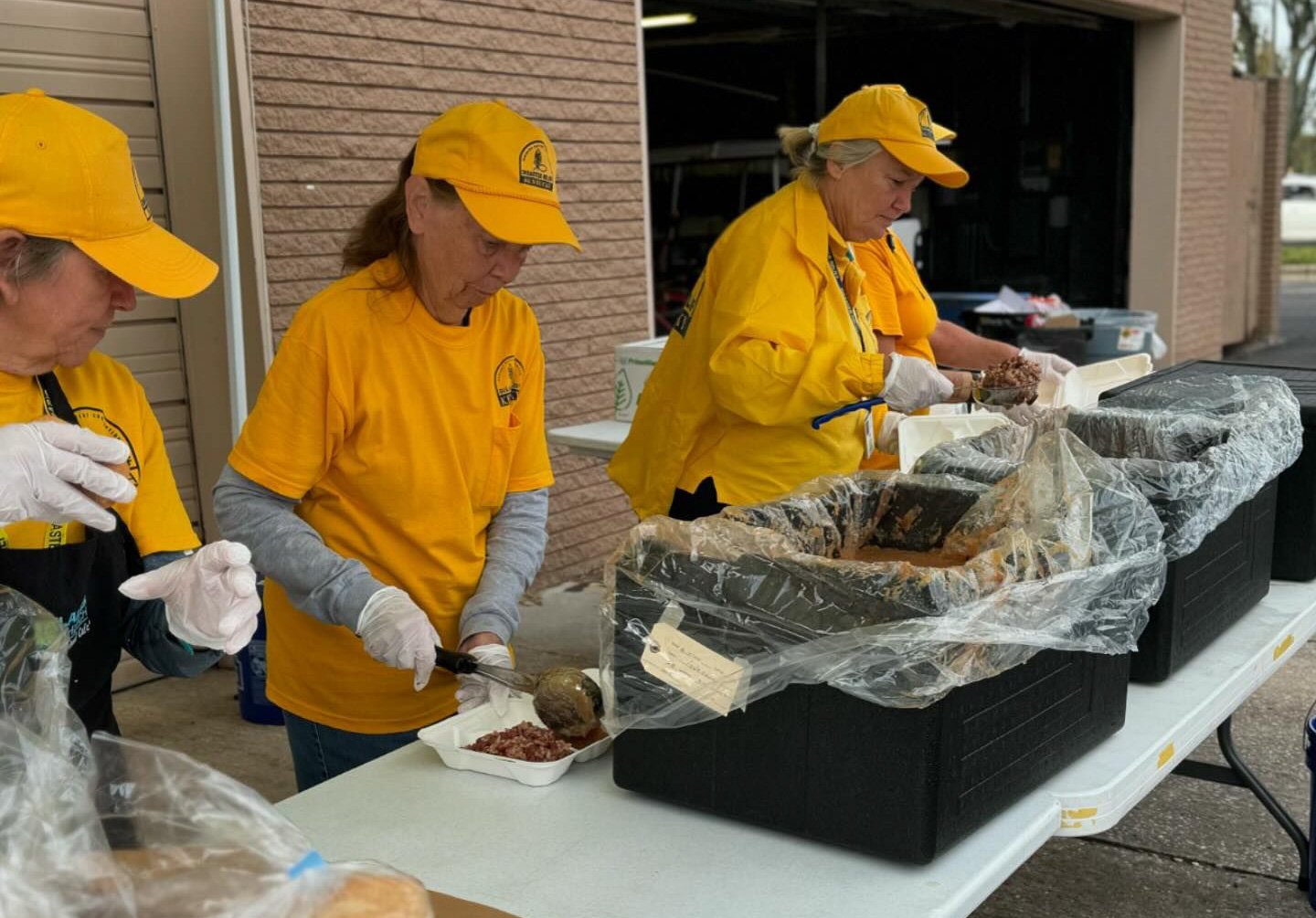 Women in bright yellow t-shirts serving food