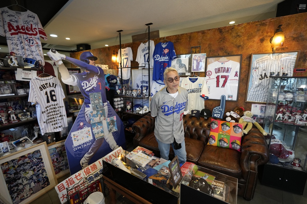 Hironobu Kanno, representative of a private fan club of Shohei Ohtani of the Los Angeles Dodgers, shows his collection items at his beauty salon in Oshu, northeastern Japan, the hometown of Ohtani, Tuesday, Oct. 29, 2024.