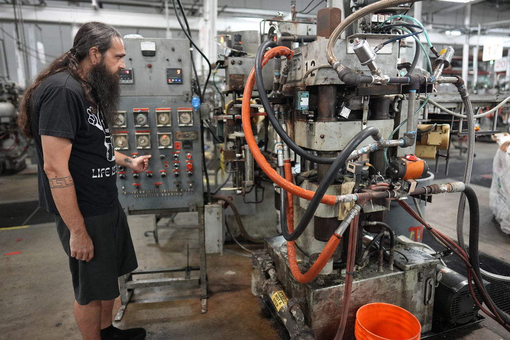 Chuck Springer operates a record pressing machine at the United Record Pressing plant