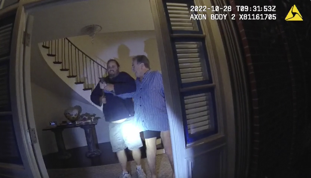 In this image taken from San Francisco Police Department body camera video, the husband of former U.S. House Speaker Nancy Pelosi, Paul Pelosi, right, fights for control of a hammer with his assailant, David DePape, during a brutal attack in the couple