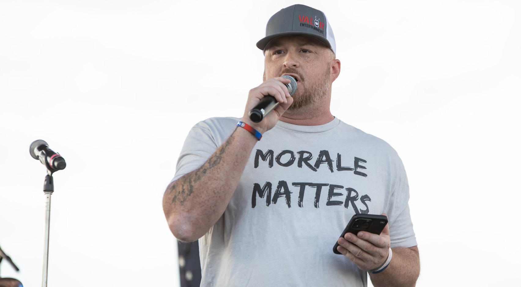 Man with microphone and t-shirt that says "Morale Matters"